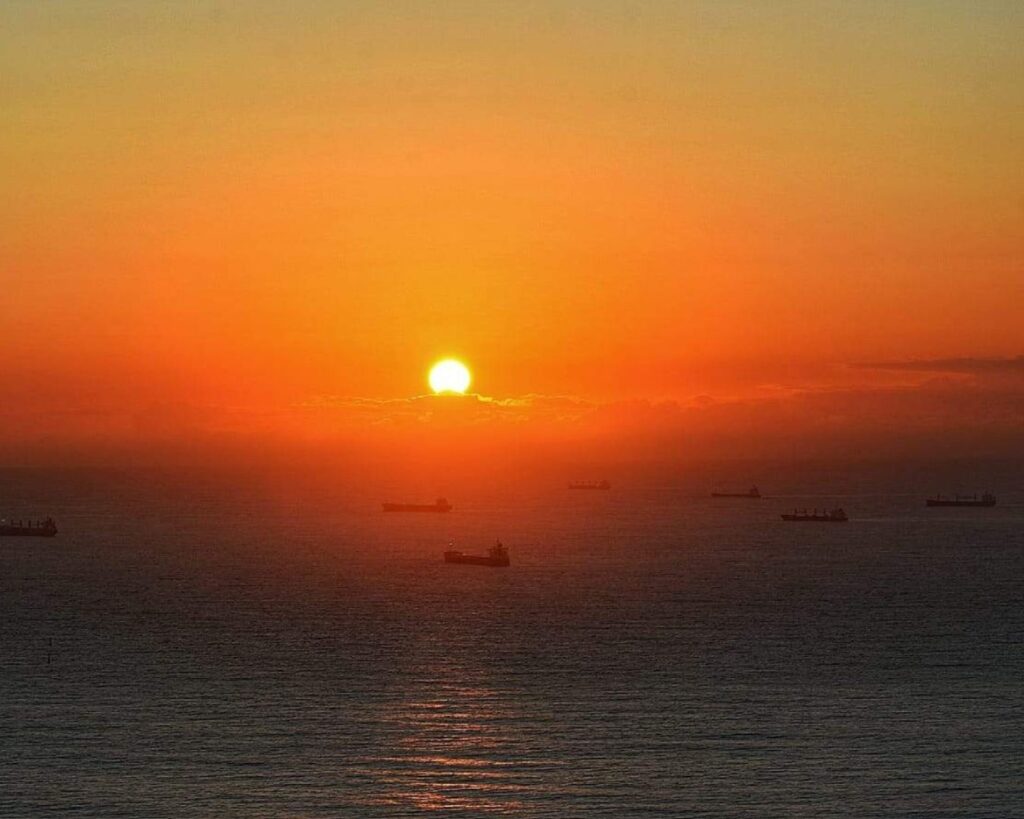 Morro do Moreno: Um guia completo para trilhas, atividades e o nascer do sol 4 Uma imagem espetacular tirada do topo do Morro, capturando o nascer do sol com a Terceira Ponte e a cidade de Vitória ao fundo. Essa foto é essencial para cumprir a promessa do título